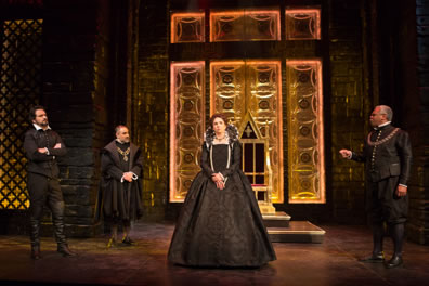 All in clothes of Tudor nobility, Leicester stands with his arms crossed, Burleigh is poised with hands clasped at his waist, Shrewsbury is extending his right hand as he makes a point, and Elizabeth stands in the center, hands folded at her waist. In the background is a throne against a golden carved wall, with the black brick pillars to either side.